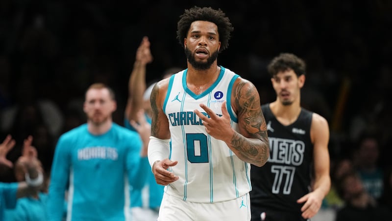 Charlotte Hornets' Miles Bridges (0) gestures after making a three-point shot during the...