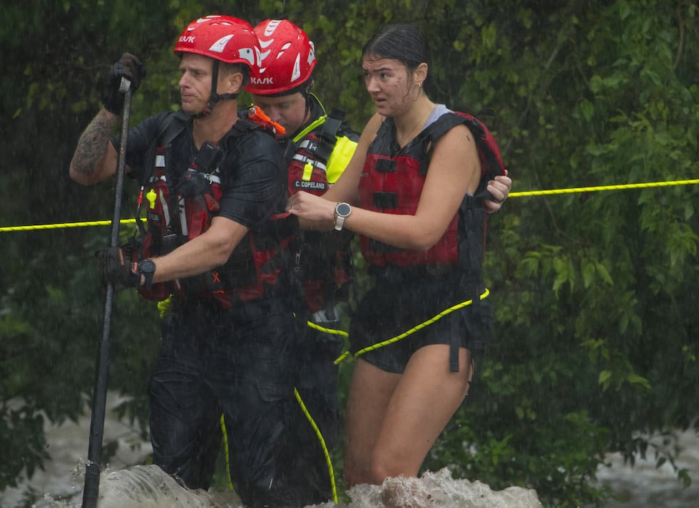 Members of the Boerne Fire Dept. rescue a woman from flood waters on Wednesday, July 15, 2026,...