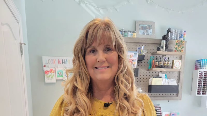 Lori Wolfe shows off her hand made Christmas cards.