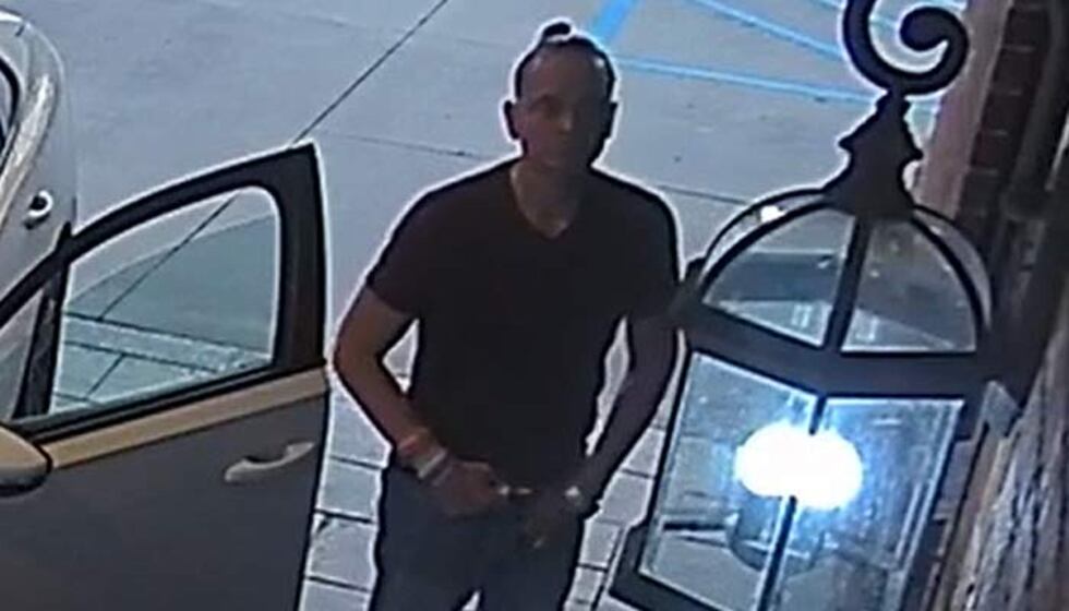 Investigators say a man with his hair pulled into a bun gets out of a Volkswagon, possibly a...